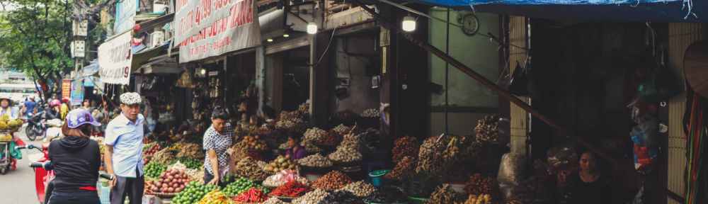 person in scooter in front of vegetables