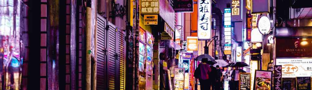 woman walking in the street during night time
